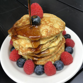 Gluten-free Two Ingredient Pancakes with berries and maple syrup