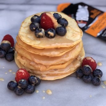 Stack of gluten-free pancakes with FBOMB nut butter