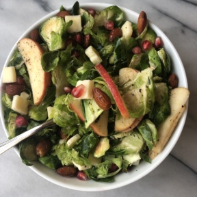 Shredded Brussels Sprouts and Apple Salad with cheddar, almonds, pomegranate