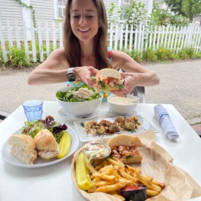Jackie eating lobster at Brix + Brine