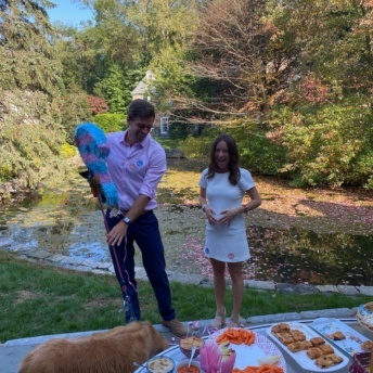Jackie and Brendan with gender reveal pinata