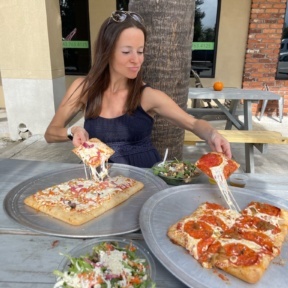 Jackie eating gluten-free pizza from Slice Co.